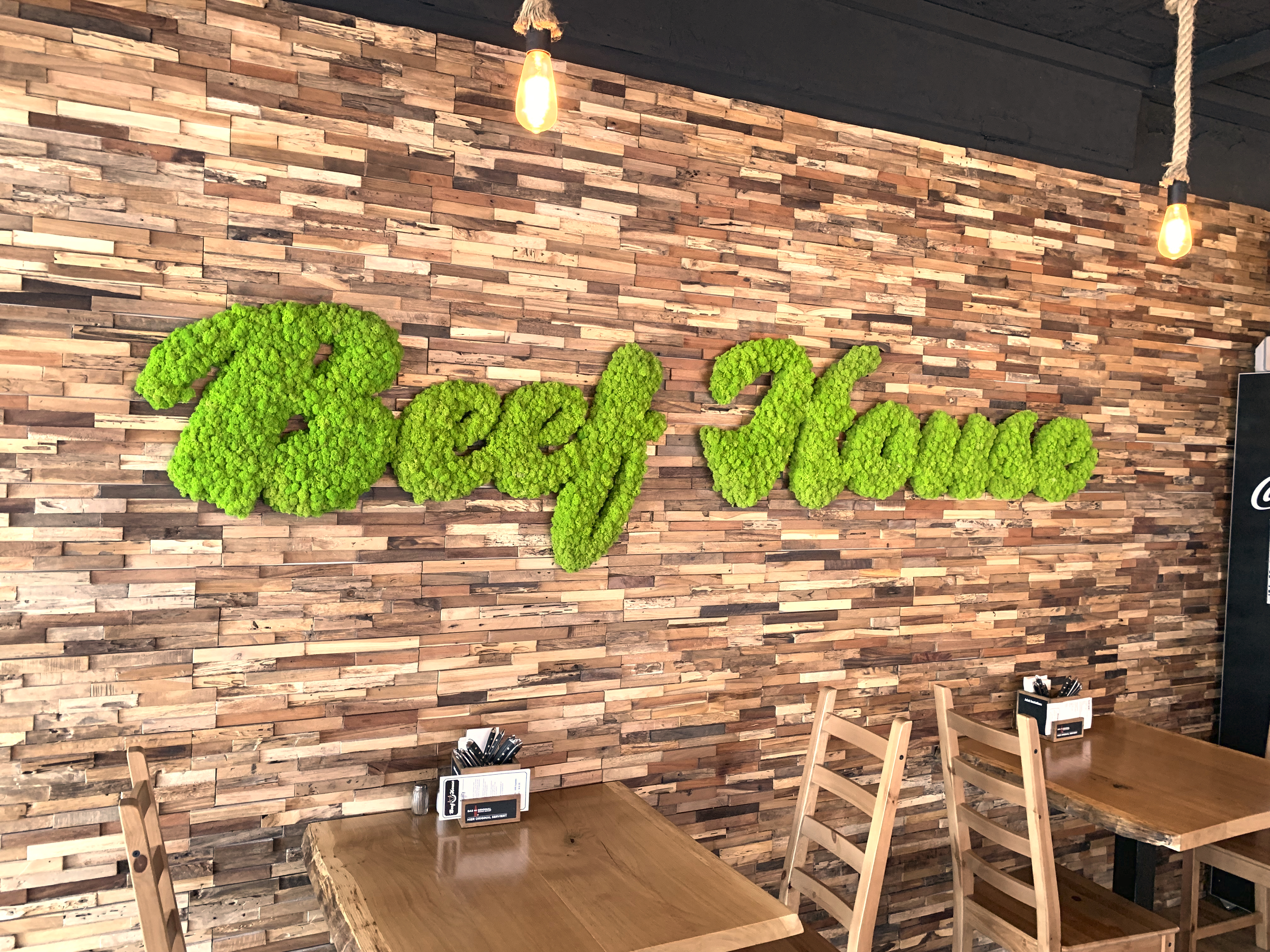 Mooslogo in einem Caffee mit einer Holzwand