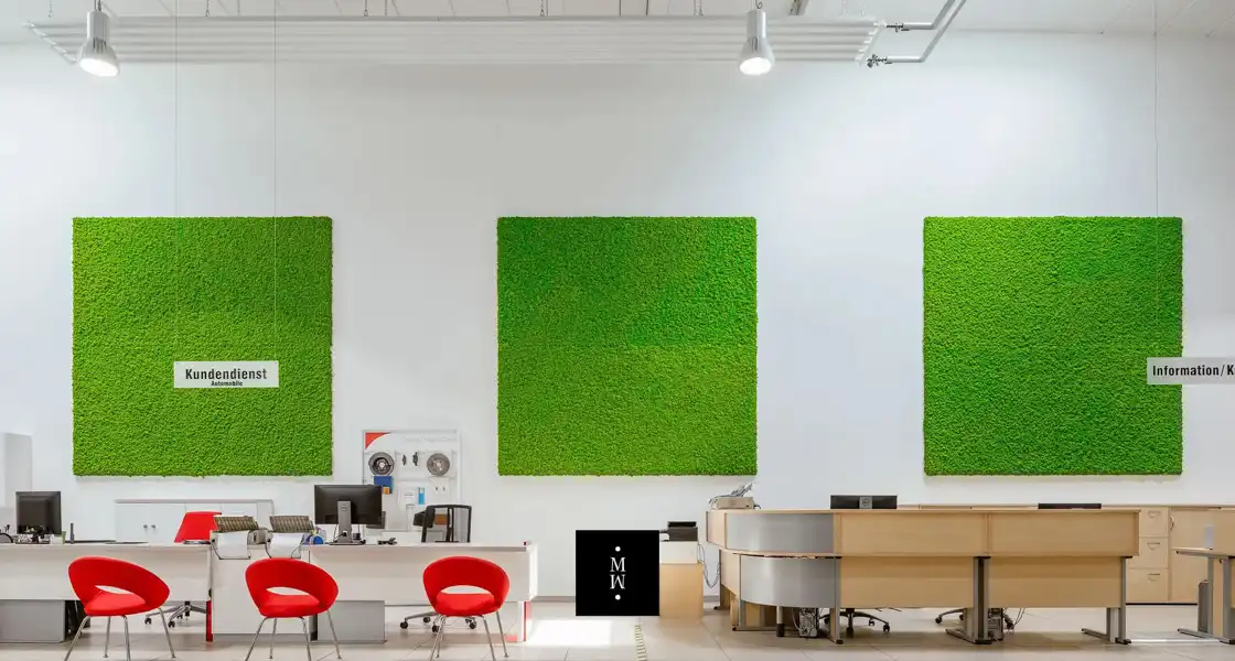 a room with a green square wall art and a desk