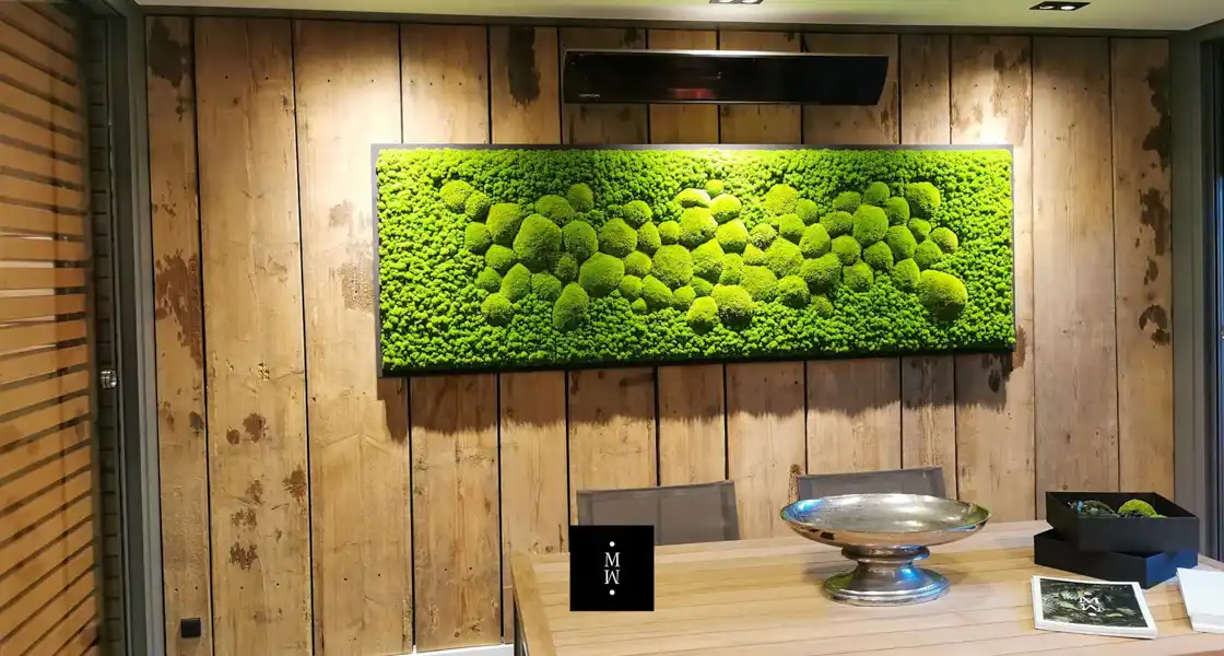 a green wall art on a wood wall