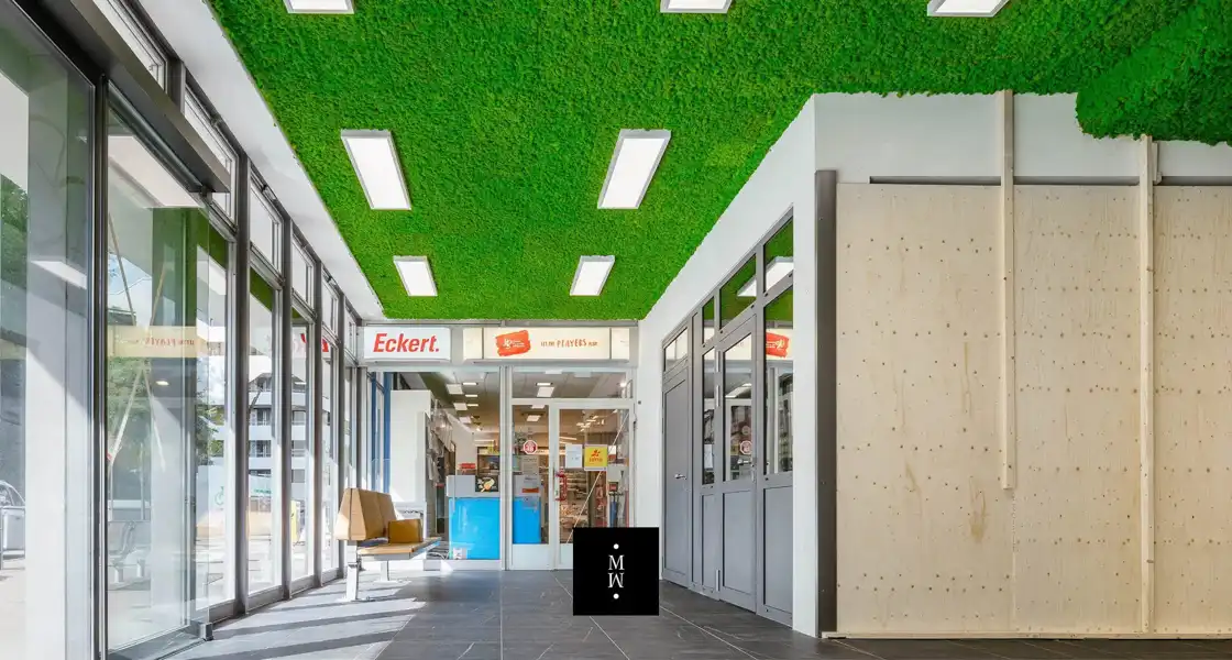 a green ceiling with lights and a sign