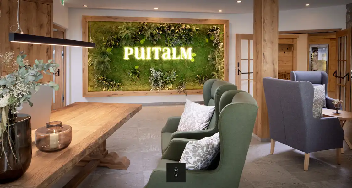 a room with a green wall and chairs