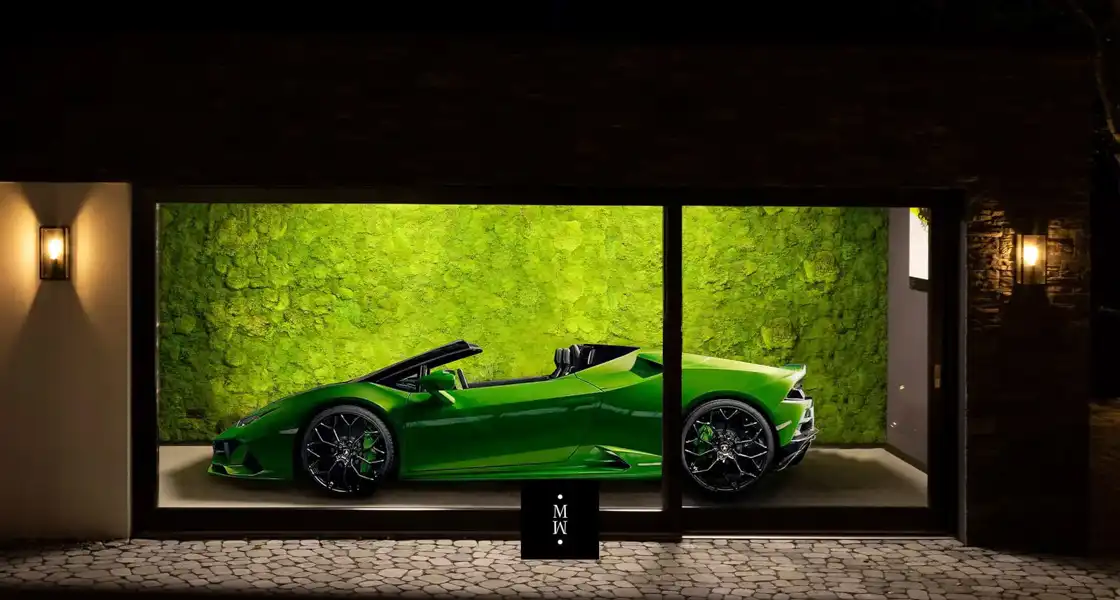 a green sports car in a room