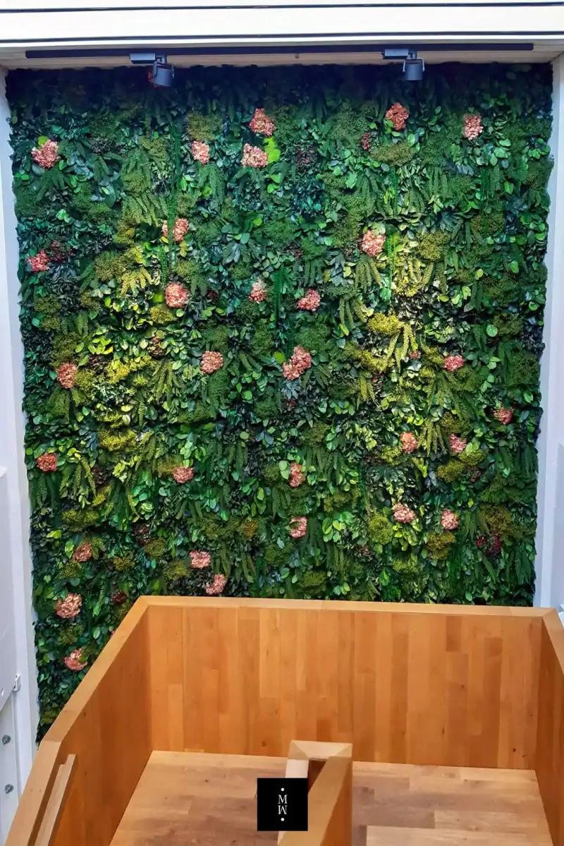 a green wall with flowers and wood floors